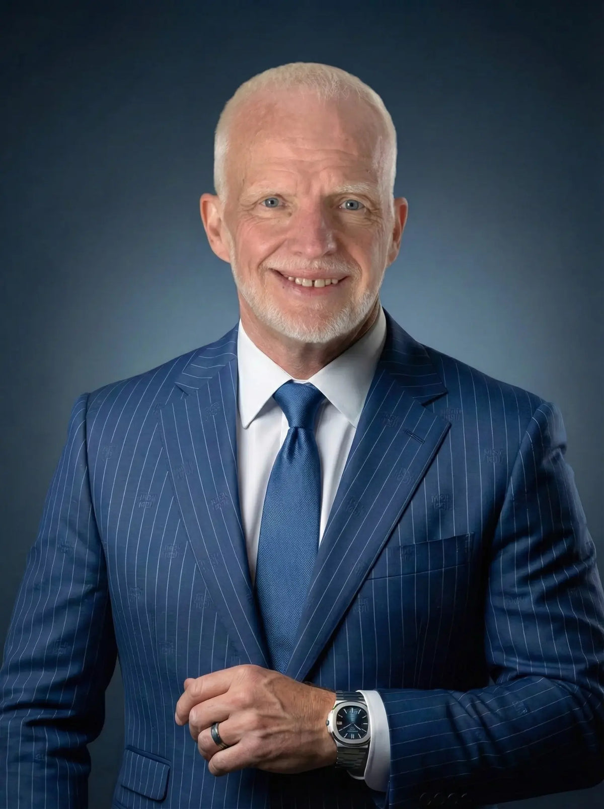 Professional headshot of Rob from Exodus Strong in a blue pinstripe suit.