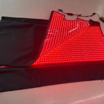 Red Light+ Blanket half open from the side, the lit panel and the controller cables