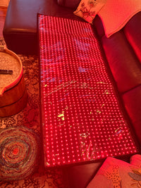 Total Body Reset mat glowing — full LED array, thin edge profile