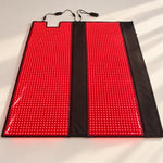 Red Light+ Blanket opened flat on a studio floor, both panels lit