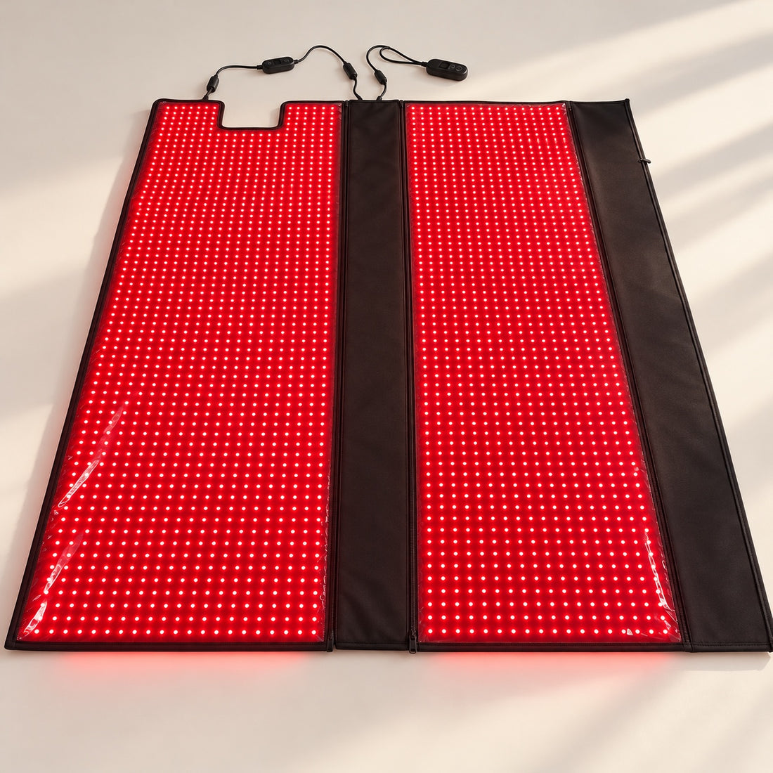 Red Light+ Blanket opened flat on a studio floor, both panels lit