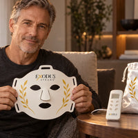 A man holding the white Red Light+ Face Mask