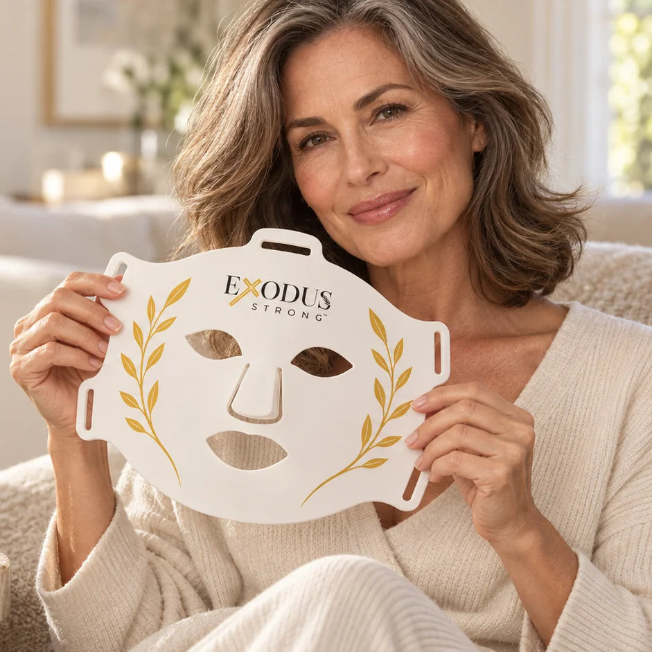 A woman in her fifties holding the white Red Light+ Face Mask